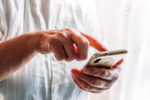 Older woman hands. Using touch screen phone. Old people and technology